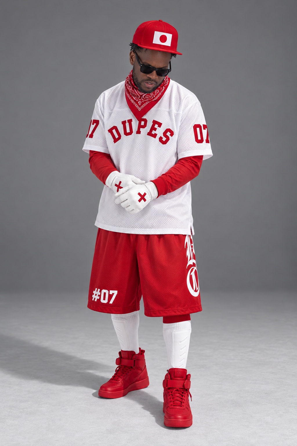 Dupes in a white DUPES jersey and red number 07 shorts, red cap and sneakers, adjusting white gloves